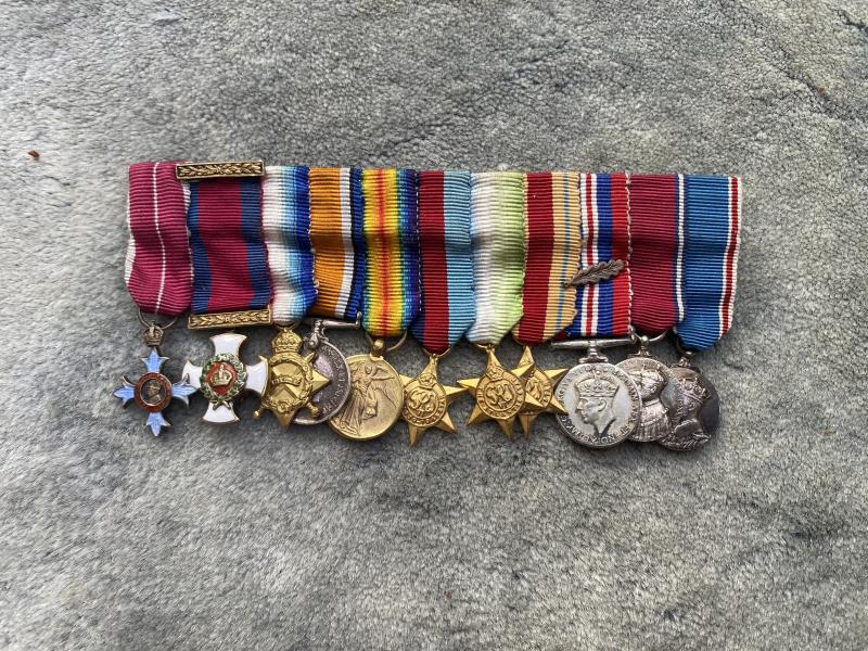 A FANTASTIC GROUP OF 11 MINIATURE MEDALS WITH A CBE & DSO COVERING WW1 & WW2.