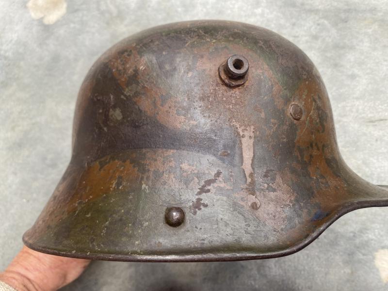 A GREAT EXAMPLE OF A WW1 M18 STEEL HELMET WITH PERIOD CAMOUFLAGE PAINT.