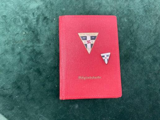 National Socialist Women's League (NS-Frauenschaft) membership red cover and small lapel badge.