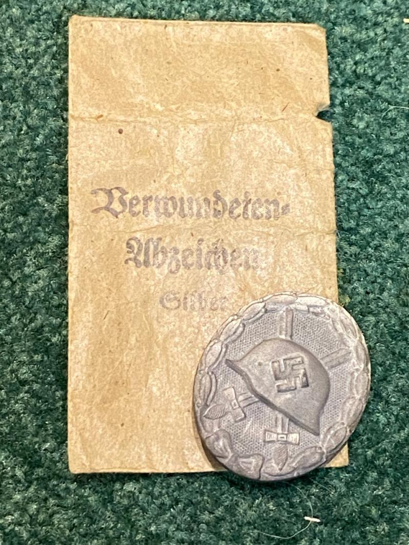 THIRD REICH SILVER WOUND BADGE WITH ORIGINAL PACKET OF ISSUE.